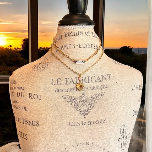 Gold toned chains with black, white, gold, and pastel pink enamel charms. - Picture 10 of 17